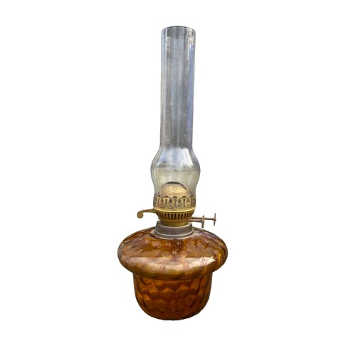 67 - AN ANTIQUE AMBER GLASS HONEYCOMB PATTERNED BRACKET/HANGING OIL LAMP WITH FUNNEL