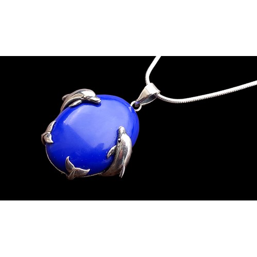 224 - A SILVER MOUNTED DOLPHIN PENDANT SET WITH A BLUE LAPIS ON SILVER CHAIN