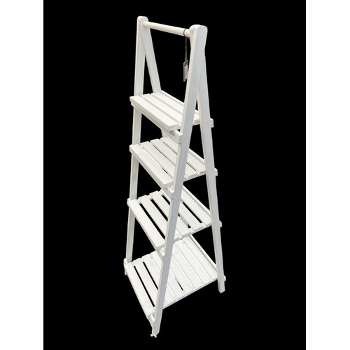 77 - A NEW WHITE FOLDING KITCHE/TOWEL RACK APPROX 60