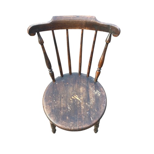 128 - AN ANTIQUE SPIDDLE BACKED CHAIR WITH A STRECHER BASE HAS HAD WORM