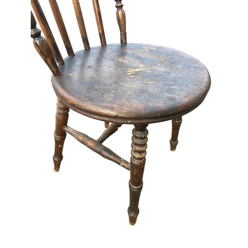 128 - AN ANTIQUE SPIDDLE BACKED CHAIR WITH A STRECHER BASE HAS HAD WORM