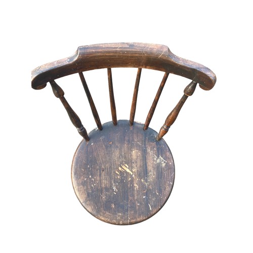 128 - AN ANTIQUE SPIDDLE BACKED CHAIR WITH A STRECHER BASE HAS HAD WORM