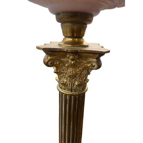 158 - A BEAUTIFULLY EMBOSSED RUBY BOWL OIL LAMP ON A BRASS PILLAR CONVERTED TO ELECTRIC