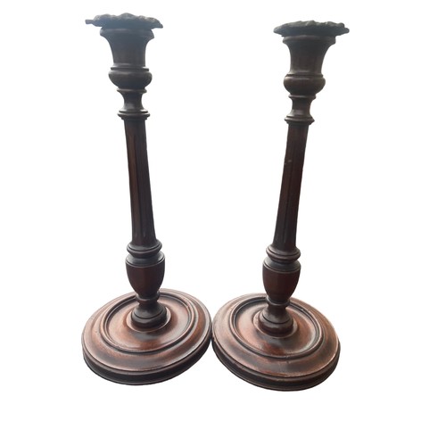 362 - A PAIR OF HAND TURNED REIDED MAHOGANY CANDLESTICKS