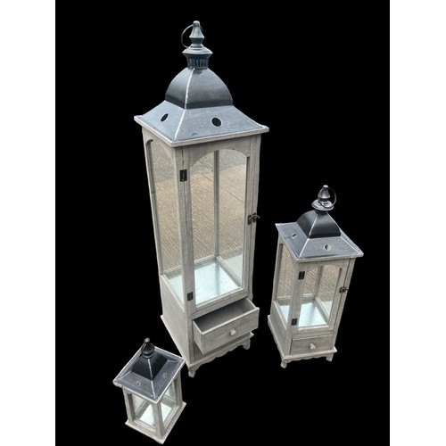 403 - A NEW SET OF 3 GRADUATED GREY FINISH CANDLE LANTERNS 2 OF WHICH HAVE DRAWRS TALLEST 48