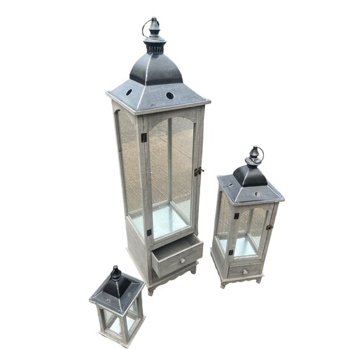 403 - A NEW SET OF 3 GRADUATED GREY FINISH CANDLE LANTERNS 2 OF WHICH HAVE DRAWRS TALLEST 48