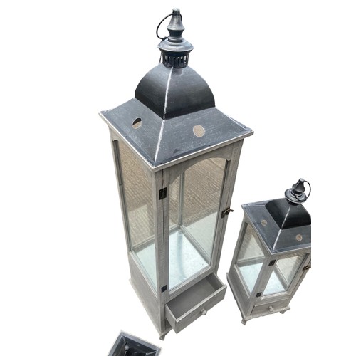 403 - A NEW SET OF 3 GRADUATED GREY FINISH CANDLE LANTERNS 2 OF WHICH HAVE DRAWRS TALLEST 48