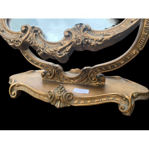 639 - AN ORNATE GILT FINISHED DRESSING MIRROR WITH CHERUB TO THE TOP