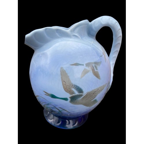 700 - A 1938 FALCON WARE SHAPED JUG DISPLAYING DUCKS IN FLIGHT