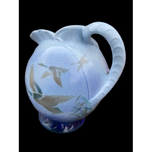 700 - A 1938 FALCON WARE SHAPED JUG DISPLAYING DUCKS IN FLIGHT