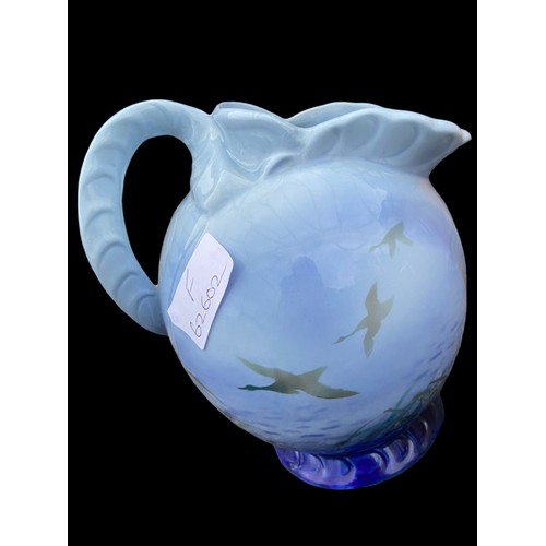 700 - A 1938 FALCON WARE SHAPED JUG DISPLAYING DUCKS IN FLIGHT