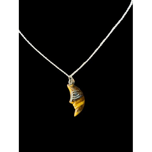 208A - A TIGERS EYE CRESENT MOON PENDANT ON A SILVER CHAIN