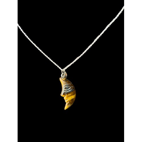 208A - A TIGERS EYE CRESENT MOON PENDANT ON A SILVER CHAIN