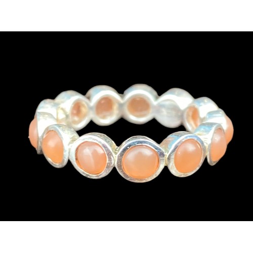 210A - A QUALITY SILVER ETERNITY RING SET WITH CORAL STYLE STONES