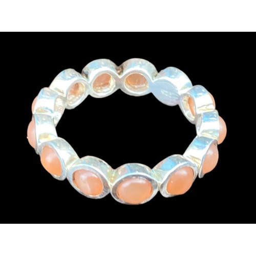 210A - A QUALITY SILVER ETERNITY RING SET WITH CORAL STYLE STONES