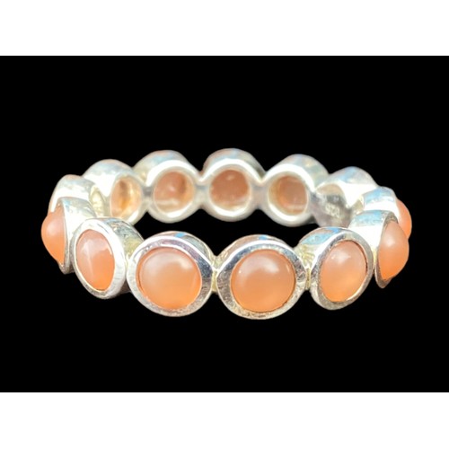 210A - A QUALITY SILVER ETERNITY RING SET WITH CORAL STYLE STONES