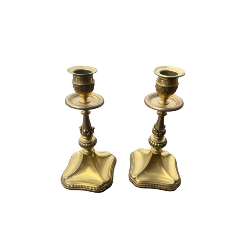56 - A PAIR OF ORNATE SHAPED HEAVY BRASS CANDLESTICKS 7.5
