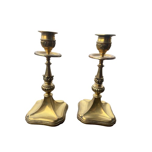 56 - A PAIR OF ORNATE SHAPED HEAVY BRASS CANDLESTICKS 7.5