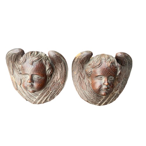 215 - A PAIR OF HEAVILY CARVED CHERUBS IN OAK APPROX 4.5