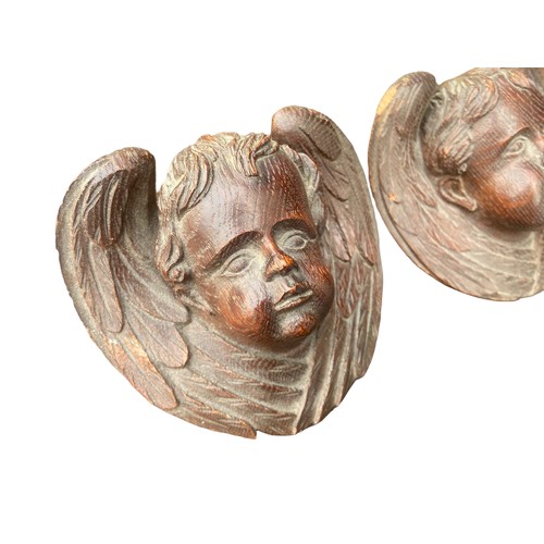 215 - A PAIR OF HEAVILY CARVED CHERUBS IN OAK APPROX 4.5