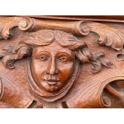 253 - A HEAVILY CARVED OAK PLAQUE 15 x 7.5