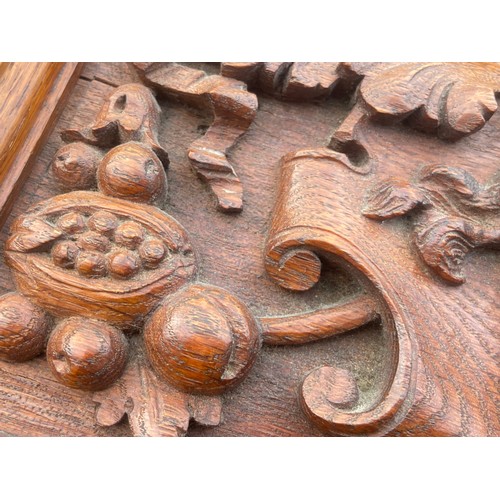 253 - A HEAVILY CARVED OAK PLAQUE 15 x 7.5