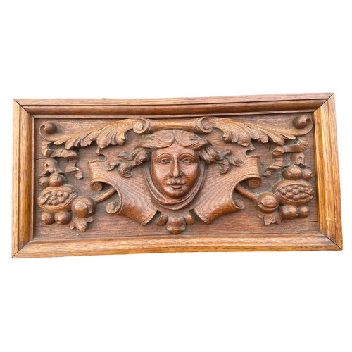 253 - A HEAVILY CARVED OAK PLAQUE 15 x 7.5