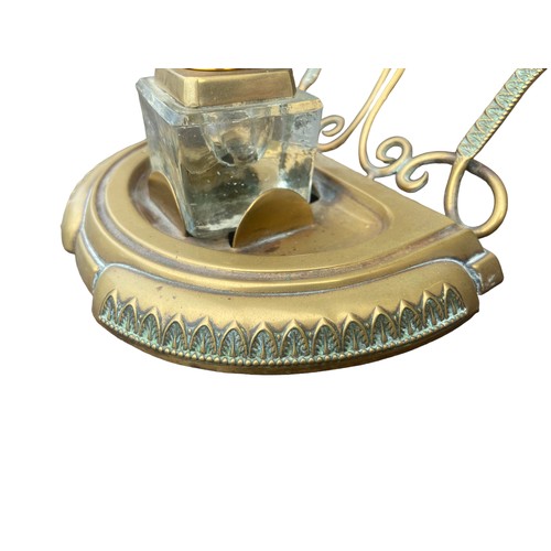 256 - AN ORNATE BRASS INKWELL STAND COMPLETE WITH AN INKWELL