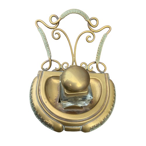 256 - AN ORNATE BRASS INKWELL STAND COMPLETE WITH AN INKWELL