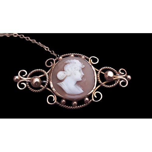 487 - A 9ct CAMEO BAR BROOCH WITH CIRCULAR PATTERNS 5grm