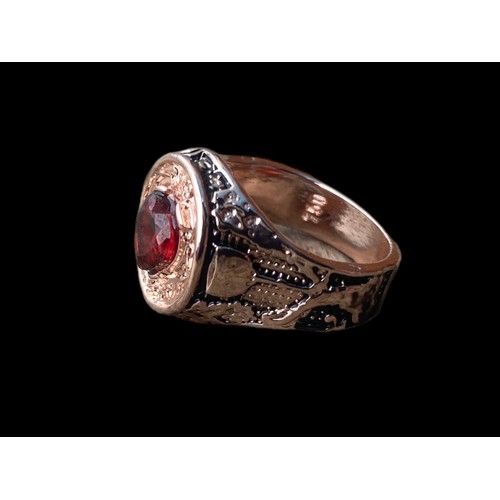 559 - ROSE GOLD COLOURED GARNET SET RING