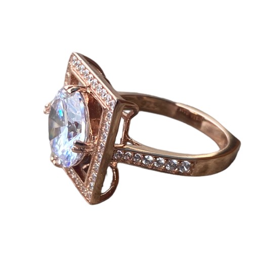 566 - A ROSE GOLD PLATED SILVER GEM SET RING