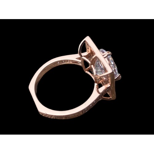 566 - A ROSE GOLD PLATED SILVER GEM SET RING