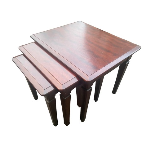 67 - A NEST OF MAHOGANY TABLES