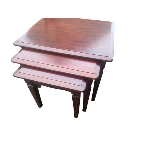 67 - A NEST OF MAHOGANY TABLES