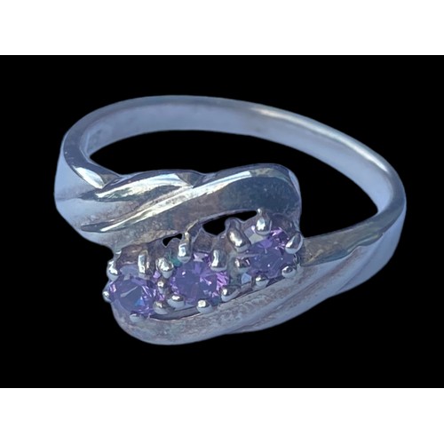 177 - AN ORNATE TWIST SILVER RING SET WITH AMETHYST