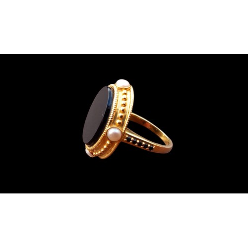 553 - A LARGE OVAL BLACK STONE RING 4 PEARLS TO THE OUTER MOUNT & BLACK STONES TO SHOULDER