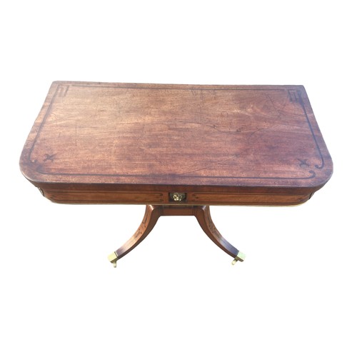 604 - A REGENCY INLAID BRASS MOUNTED CARD TABLE ADORNED WITH A BRASS LOIN HEAD ON A QUAD BASE OF IMMENSE Q... 