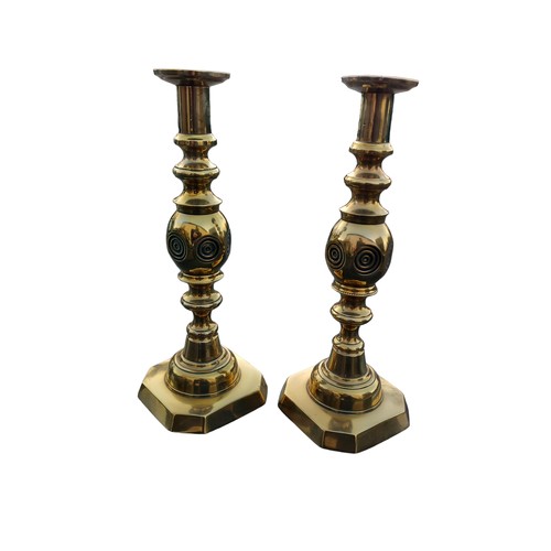 612 - A PAIR OF HEAVY BULLS EYE BRASS CANDLESTICKS 12