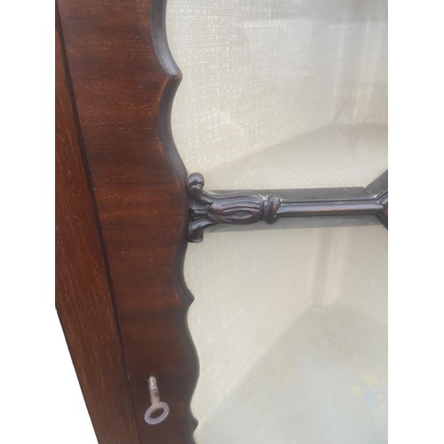 84 - AN ANTIQUE MAHOGANY ASTRO GLAZED CORNER DISPLAY CABINET