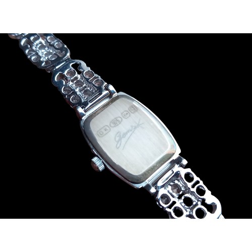 255 - A SILVER WATCH WITH RECTANGULAR M.O.P DIAL ON WHITE STONE BRACELET GEMS MADE