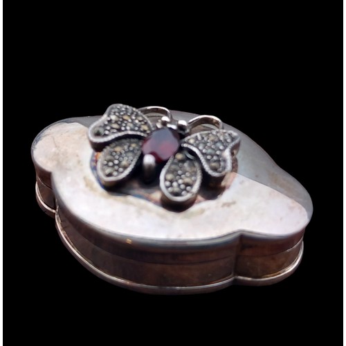 259 - A SILVER PILL BOX ADORNBED WITH A BUTTERFLY SET WITH A MARACSITE & GARNET