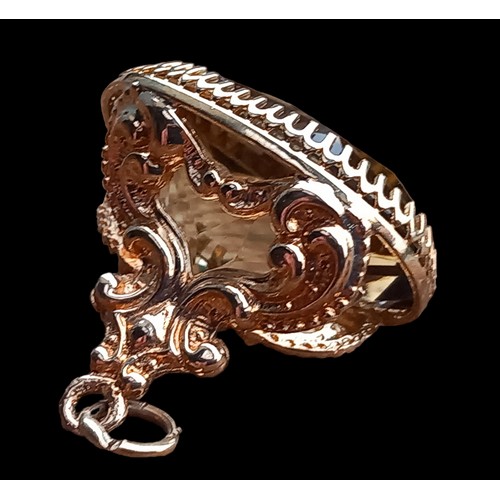 581 - A 9cct GOLD FOB 3cm LENGTH WITH QUARTZ STONE IN SCROLL MOUNT