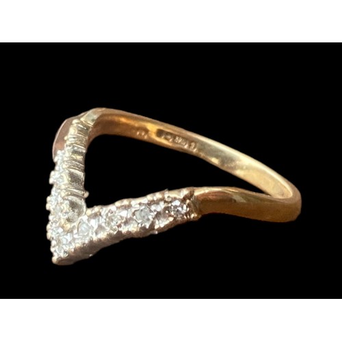 566 - A 9CT GOLD DIAMOND WISHBONE RING