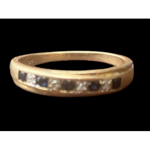 571 - A 9CT GOLD RING SET WITH 5 SAPPHIRES & 4 DIAMONDS WITH A YELLOW GOLD CHANNEL SET MOUNT SIZE P 1/2 2.... 