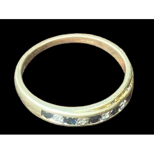 571 - A 9CT GOLD RING SET WITH 5 SAPPHIRES & 4 DIAMONDS WITH A YELLOW GOLD CHANNEL SET MOUNT SIZE P 1/2 2.... 