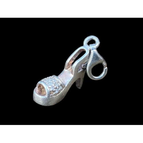 194 - A SILVER CHARM WITH HIGH HEEL CLASP AND 2 COSTUME RINGS