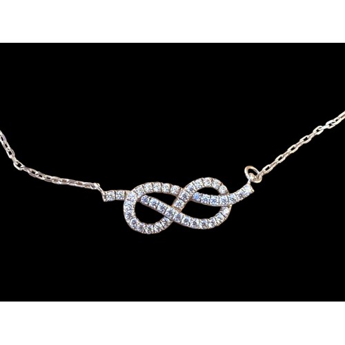 210 - A SILVER GEMSET INFINITY WRIST CHAIN