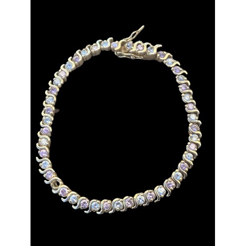 240 - A SILVER GILT GEMSET LINE BRACELET (1 STONE MISSING)