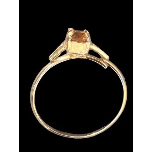 255 - A GOLD COLOURED TOPAZ SET RING SIZE R